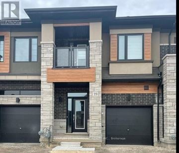 Brantford townhouse for rent - A modern two-story building with a balcony on the second floor.