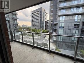 Toronto (Henry Farm) condo for rent - A balcony view of a cityscape with buildings and a road.