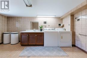 Toronto (Trinity-Bellwoods) apartment for rent - A bathroom with a sink, toilet, and trash cans.