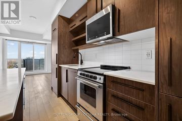 Ottawa condo for rent - A modern kitchen with wooden cabinets and stainless steel appliances.