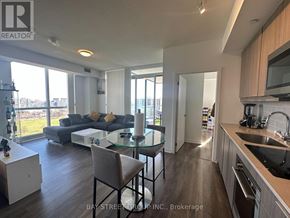 Toronto (Henry Farm) condo for rent - A modern kitchen with a dining table and chairs.