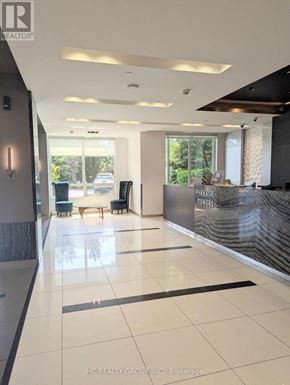 Markham (Grandview) condo for rent - A hallway with a reception desk and a window in the background.