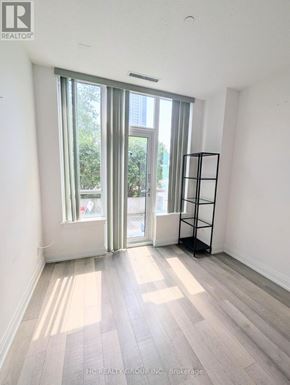 Markham (Grandview) condo for rent - A room with a large window and a wooden floor.