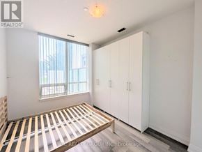 Markham (Grandview) condo for rent - A bedroom with a bed, a window, and a wardrobe.