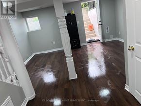 Mississauga (Churchill Meadows) townhouse for rent - A room with wooden floors and a black cabinet.