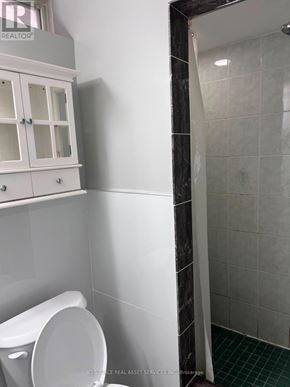 Mississauga (Churchill Meadows) townhouse for rent - A white toilet in a bathroom with a white cabinet above it.