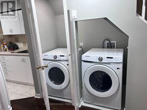 Mississauga (Churchill Meadows) townhouse for rent - A pair of white front load washing machines in a laundry room.