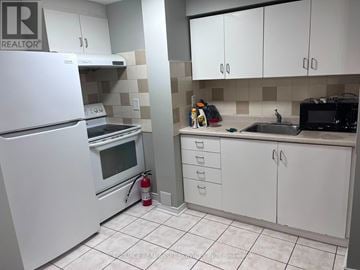Mississauga (Churchill Meadows) townhouse for rent - A white refrigerator is in a kitchen with white cabinets and a white oven.