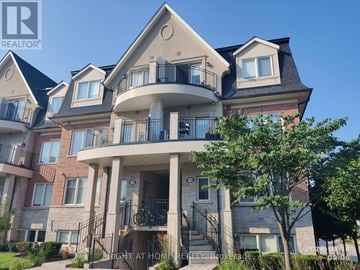Oakville (Wm Westmount) townhouse for rent - A large, multi-level residential building with balconies and a front porch.