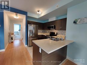 Oakville (Wm Westmount) townhouse for rent - A kitchen with a refrigerator, stove, and sink.