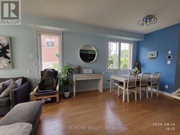 Oakville (Wm Westmount) townhouse for rent - A living room with a grey couch and a white desk with a chair.