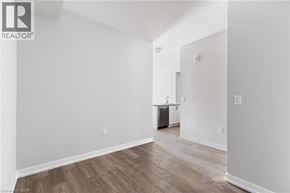 Hamilton apartment for rent - A room with wooden flooring and white walls, with a doorway leading to another room.