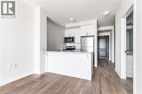 Hamilton apartment for rent - A white kitchen with wood flooring and a white island.