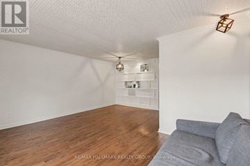 Ottawa townhouse for rent - A living room with a grey couch and a wooden floor.