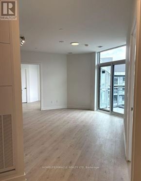 Oakville (Ga Glen Abbey) condo for rent - A room with wooden flooring and a glass door leading outside.