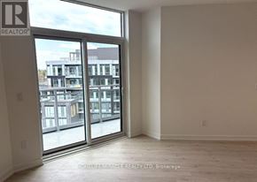 Oakville (Ga Glen Abbey) condo for rent - A room with a large window and a view of a building outside.