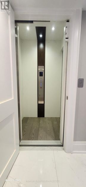 Toronto (Willowdale West) apartment for rent - A white hallway with a wooden door at the end.