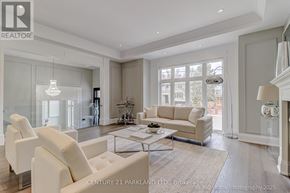 Toronto (Willowdale West) apartment for rent - A spacious living room with white furniture and a large window.