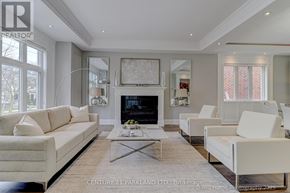 Toronto (Willowdale West) apartment for rent - A well-lit, spacious living room with a fireplace and white furniture.