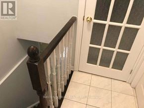 Mississauga (Erindale) apartment for rent - A white door with a glass panel and a wooden railing.