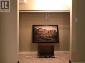 Mississauga (Erindale) apartment for rent - A framed picture of a building is on a stand in a room.