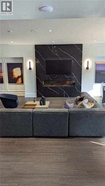 Markham condo for rent - A modern living room with a grey sofa and a black fireplace.