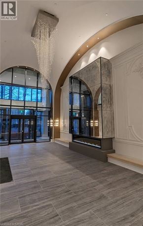 Markham condo for rent - A large, elegant room with a curved wall and a chandelier hanging from the ceiling.
