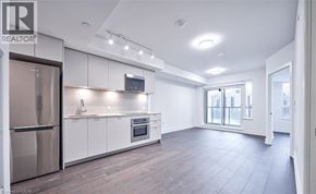 Markham condo for rent - A modern kitchen with a refrigerator, oven, and microwave.