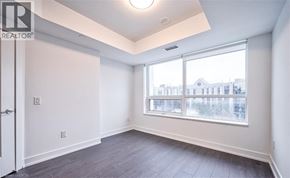 Markham condo for rent - A room with a large window and a door.