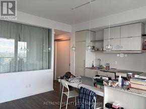 Toronto (Church-Yonge Corridor) condo for rent - A cluttered kitchen and dining area with a view of the city.