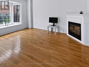 Newmarket (Woodland Hill) apartment for rent - A room with a fireplace and a lamp on a side table.