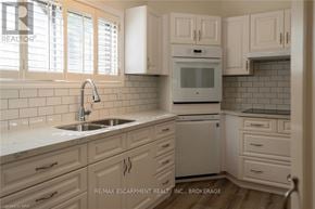 Hamilton (Inch Park) multi-family for rent - A kitchen with white cabinets and a white oven.