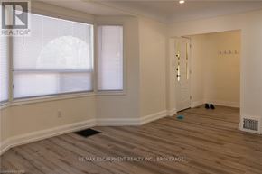 Hamilton (Inch Park) multi-family for rent - A room with a window and a door is shown.