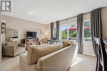 Guelph (Pineridge/Westminster Woods) townhouse for rent - A kitchen with wooden cabinets and a white refrigerator.
