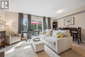 Guelph (Pineridge/Westminster Woods) townhouse for rent - A kitchen with wooden cabinets and a white refrigerator.