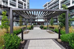 Toronto (Downsview-Roding-Cfb) condo for rent - A modern outdoor seating area with a pergola and benches.