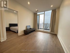 Toronto (Bayview Village) condo for rent - A bedroom with a large bed and a balcony overlooking the city.