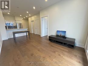 Toronto (Bayview Village) condo for rent - A living room with a wooden floor and a television on a stand.