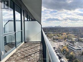 Toronto (Bayview Village) condo for rent - A balcony with glass doors overlooking a cityscape.