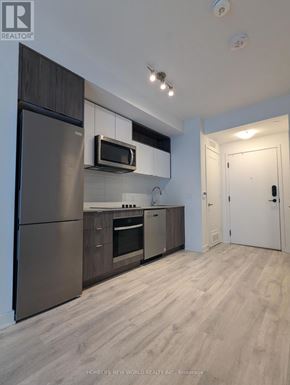 Toronto (Waterfront Communities) condo for rent - A kitchen with a refrigerator, microwave, and oven.