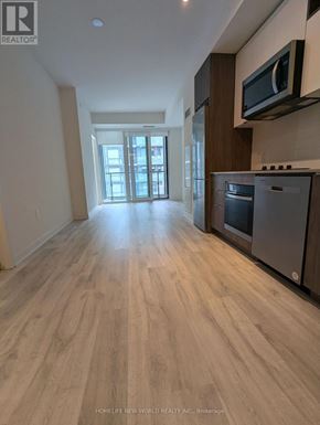 Toronto (Waterfront Communities) condo for rent - A spacious kitchen with wooden flooring and a modern design.