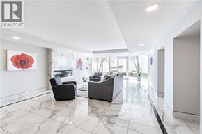 Burlington condo for rent - A living room with a grey sofa and a red flower on the wall.