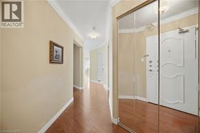 Burlington condo for rent - A hallway with a wooden floor and a white door.