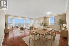 Burlington condo for rent - A well-lit, spacious living room with a dining table and chairs.