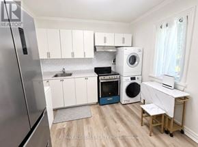Toronto (The Beaches) apartment for rent - A small kitchen with a refrigerator, oven, washing machine, and dryer.
