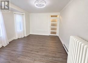 Toronto (The Beaches) apartment for rent - A room with a white ceiling, a white door, and a white radiator.
