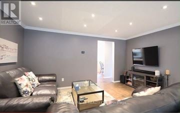 Cambridge apartment for rent - A living room with a black leather couch and a flat screen TV.