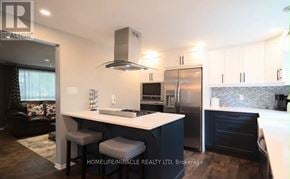 Cambridge apartment for rent - A modern kitchen with a large island and a refrigerator.