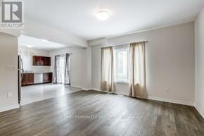 Welland (Lincoln/Crowland) apartment for rent - A spacious living room with wooden floors and a large window with curtains.