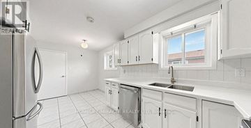 Mississauga (Malton) apartment for rent - A kitchen with white cabinets and appliances.